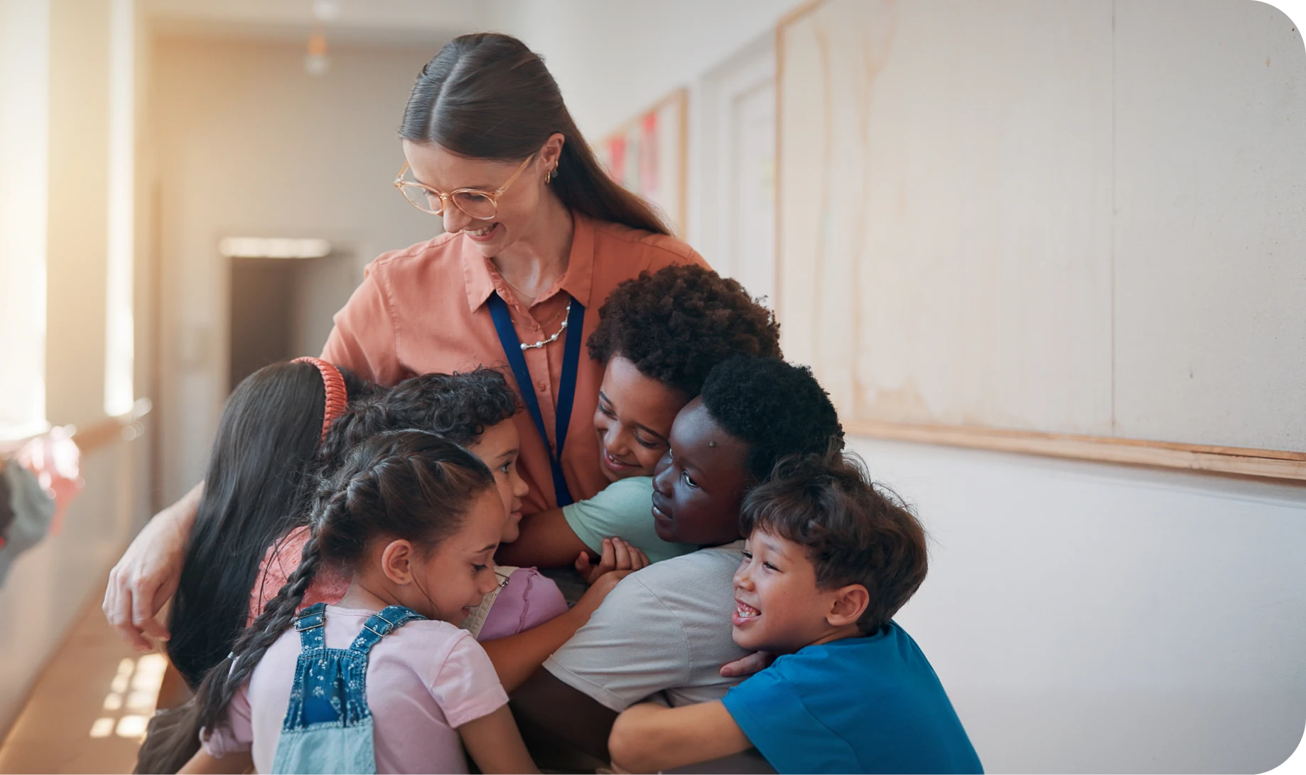 Joyful classroom hug with diverse children.
